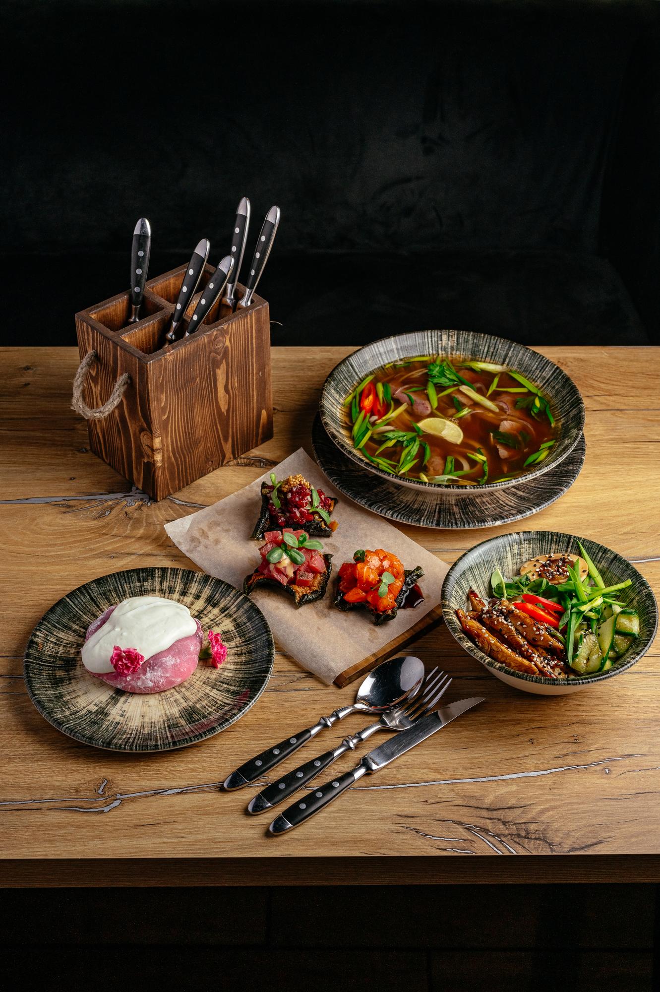 Collection of plated dishes on wooden table